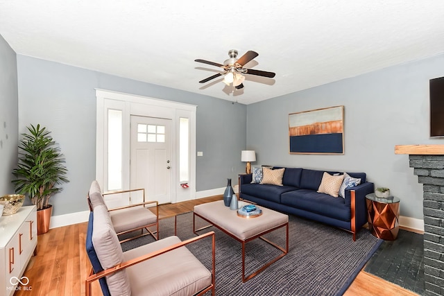 3458 N Kenwood Ave, Indianapolis, IN 46208 - living room with light wood finished floors, a ceiling fan, and a fireplace