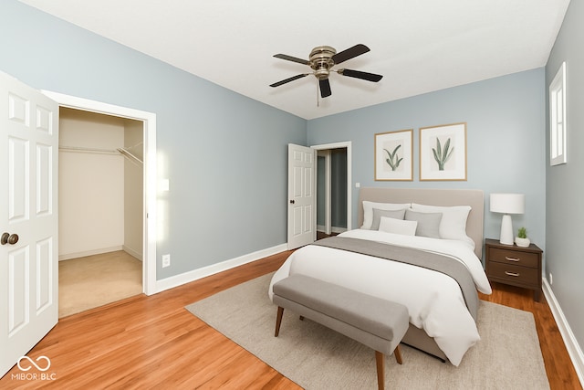 3458 N Kenwood Ave, Indianapolis, IN 46208 - bedroom featuring light wood-style floors, a spacious closet, and a ceiling fan