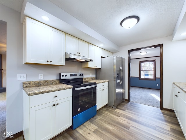 kitchen with white cabinets, appliances with stainless steel finishes, and a textured ceiling