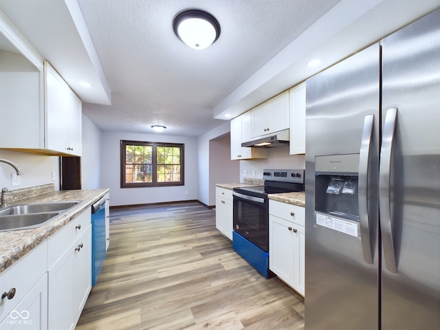 kitchen featuring white cabinetry, sink, stainless steel appliances, a textured ceiling, and light wood-type flooring