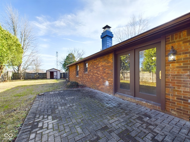 view of patio with an outbuilding