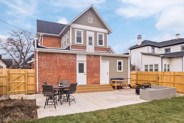 back of property with an outdoor living space and a patio