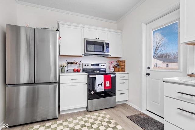 kitchen featuring light wood-type flooring, white cabinetry, crown molding, and appliances with stainless steel finishes