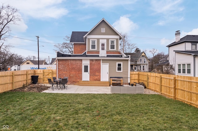 rear view of house featuring a patio and a lawn