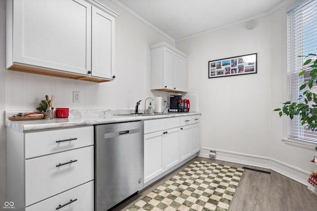 kitchen with dishwasher, white cabinetry, ornamental molding, and sink