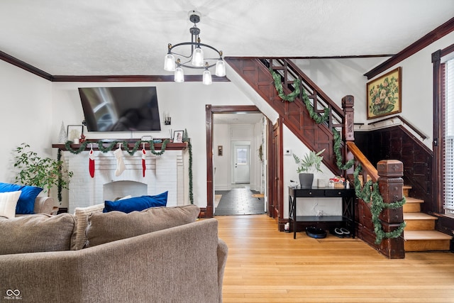 living room with ornamental molding, hardwood / wood-style flooring, and a notable chandelier