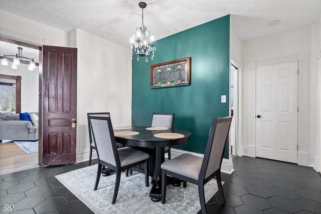 dining area featuring dark hardwood / wood-style flooring and an inviting chandelier