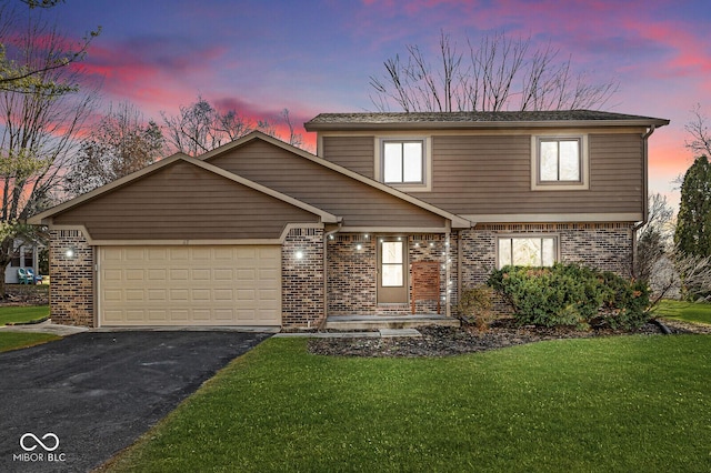 view of front property with a yard and a garage