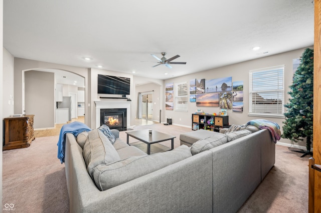 living room featuring light carpet and ceiling fan