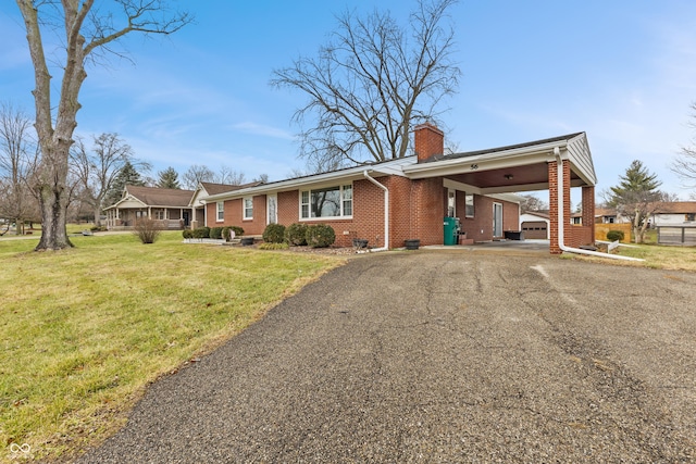 ranch-style home with a front lawn and a carport