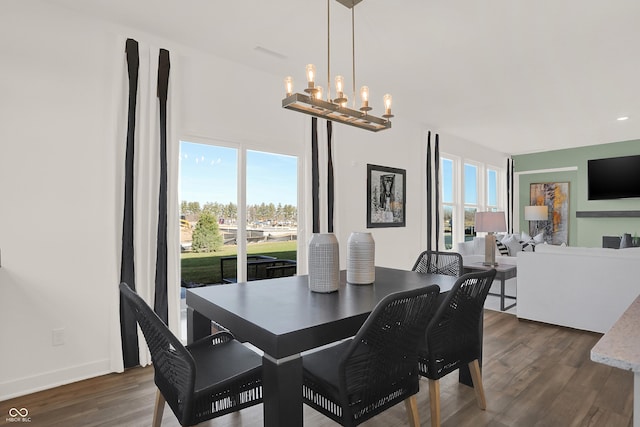 dining room featuring a chandelier, dark hardwood / wood-style flooring, and a healthy amount of sunlight