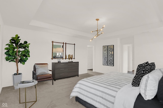 bedroom with a tray ceiling, light carpet, and an inviting chandelier