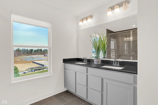 bathroom with tile patterned flooring, vanity, and an enclosed shower