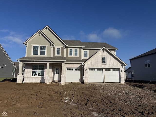 craftsman inspired home featuring covered porch and a garage