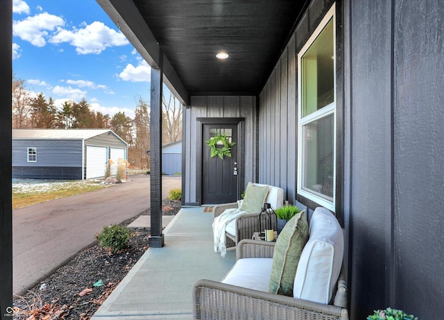 view of patio / terrace with a garage and an outdoor structure