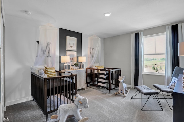 bedroom with carpet and a nursery area