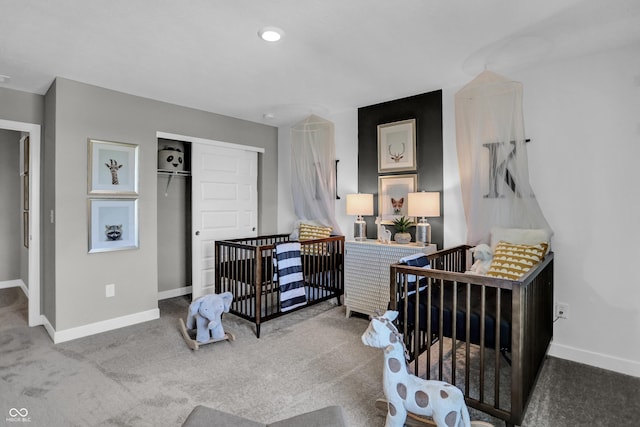 bedroom featuring carpet flooring, a crib, and a closet