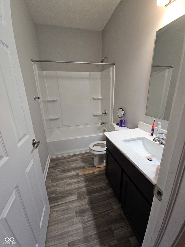 full bathroom with toilet, vanity, shower / bathtub combination, and hardwood / wood-style flooring