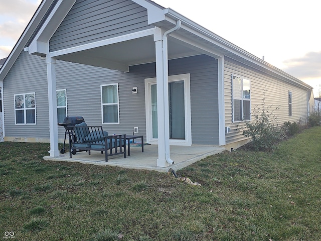 rear view of property featuring a yard and a patio area