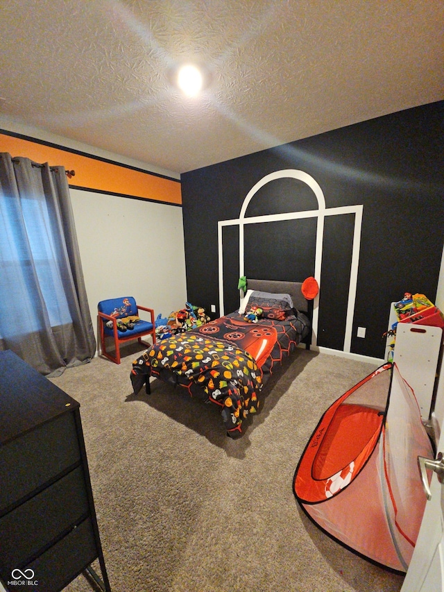 carpeted bedroom featuring a textured ceiling