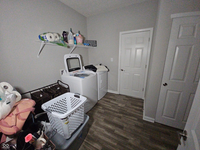 laundry area with dark hardwood / wood-style flooring and separate washer and dryer