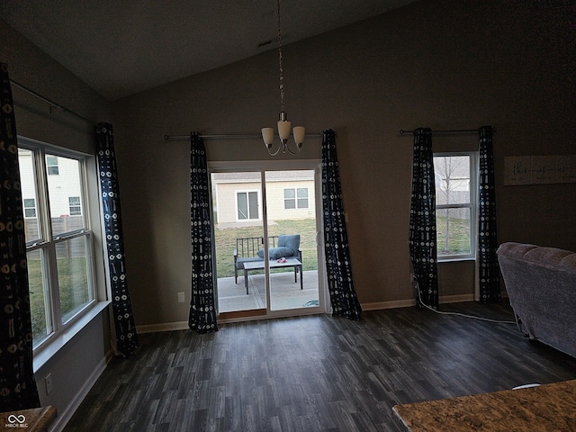 spare room featuring a notable chandelier, dark hardwood / wood-style flooring, and lofted ceiling