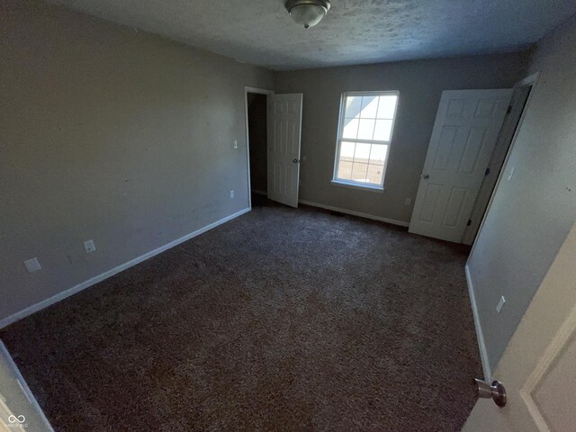 6215 E 11th St, Indianapolis, IN 46219 - spare room with carpet floors and a textured ceiling