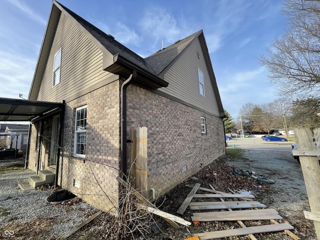 6215 E 11th St, Indianapolis, IN 46219 - view of property exterior with entry steps, brick siding, and crawl space