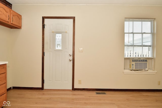 entrance foyer featuring cooling unit and light wood-type flooring