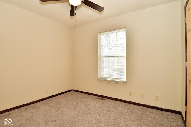 unfurnished room with ceiling fan and light colored carpet