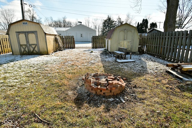 view of yard featuring a storage unit and a fire pit