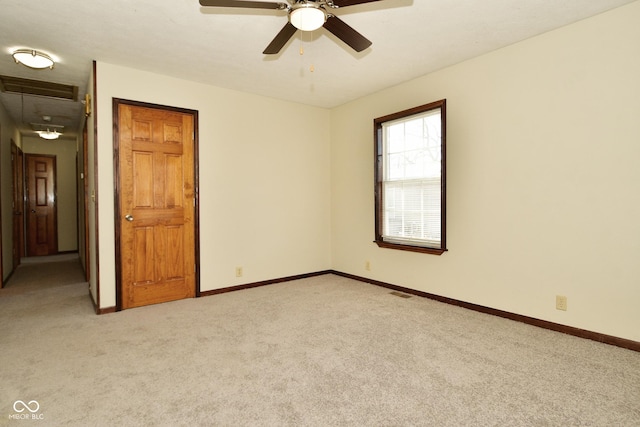 carpeted empty room featuring ceiling fan