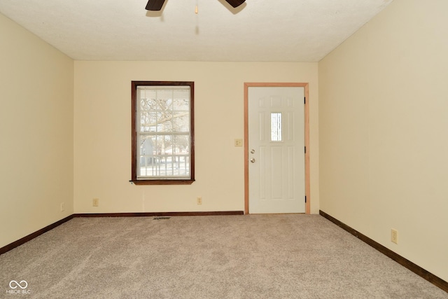 entryway with light carpet and ceiling fan