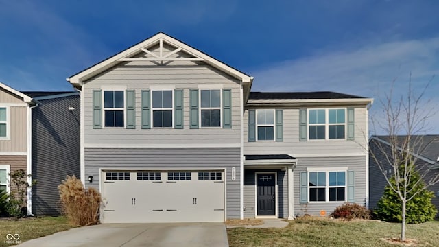 view of front facade with a front yard and a garage