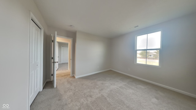 unfurnished room with light colored carpet