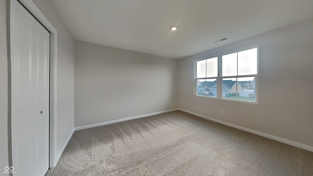 unfurnished bedroom with carpet flooring and a closet