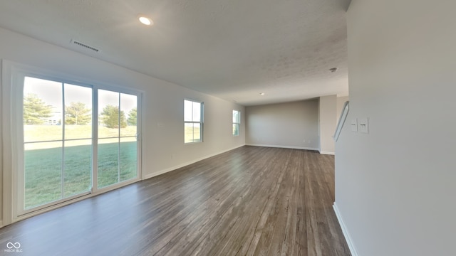 empty room featuring dark hardwood / wood-style flooring