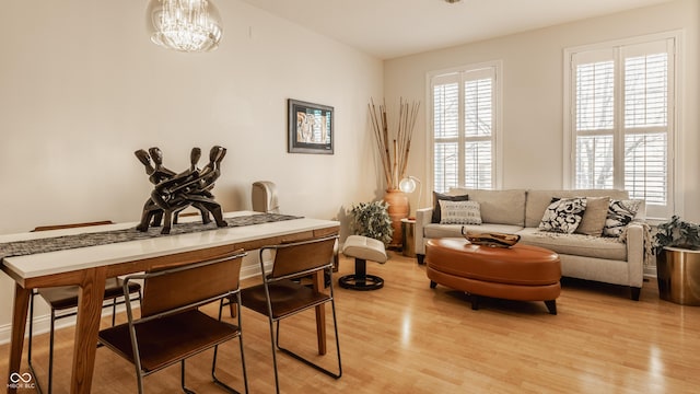 sitting room featuring light hardwood / wood-style flooring and a notable chandelier