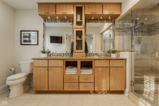 bathroom with tile patterned flooring, vanity, and walk in shower