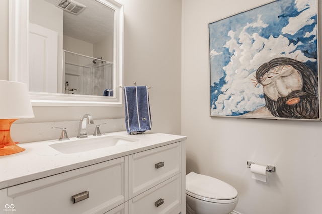 bathroom with vanity, toilet, and walk in shower