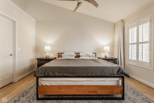 bedroom with ceiling fan, light hardwood / wood-style floors, and lofted ceiling