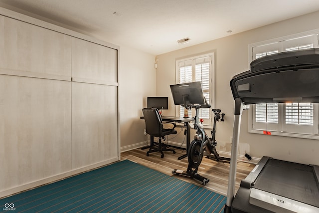 workout area with hardwood / wood-style floors