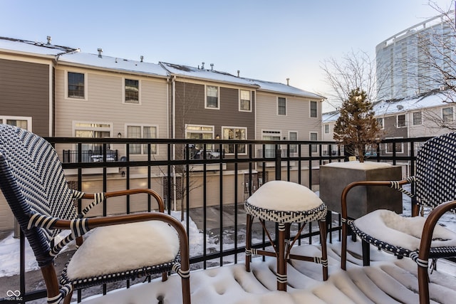 view of snow covered back of property