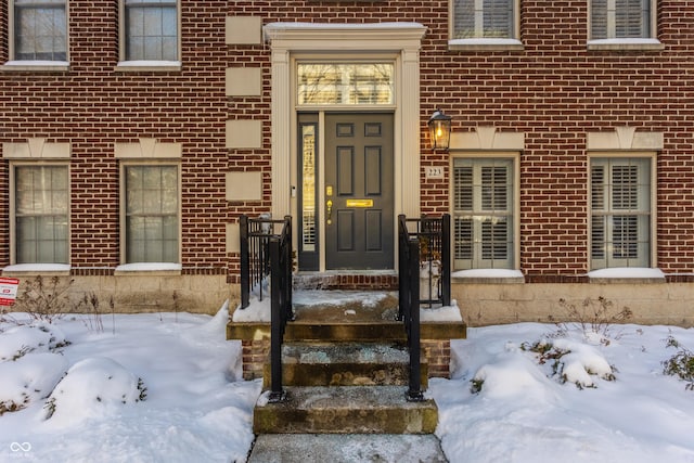 view of snow covered property entrance