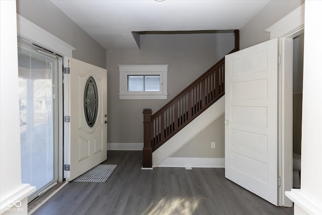 entryway with dark hardwood / wood-style flooring