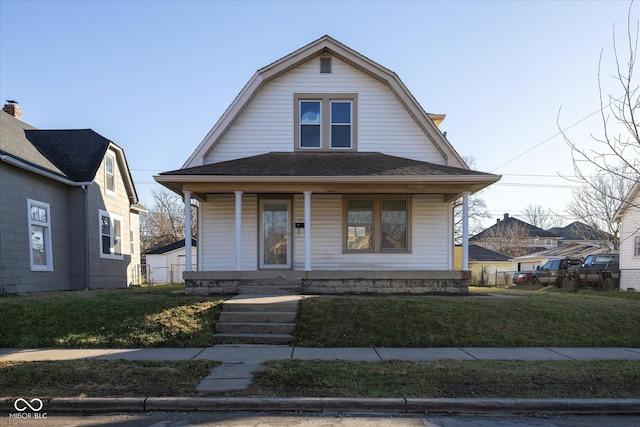 bungalow featuring a porch and a front lawn