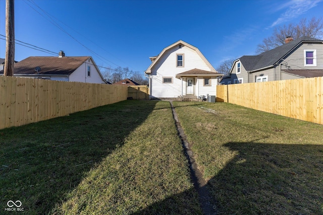 back of house with a lawn