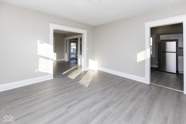 spare room featuring light hardwood / wood-style flooring