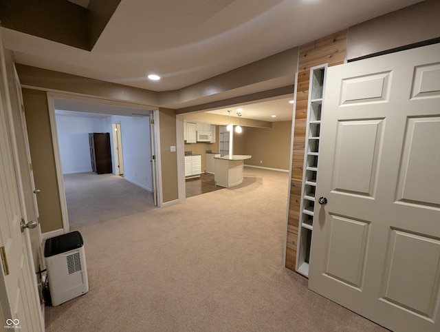 corridor with wooden walls and carpet floors