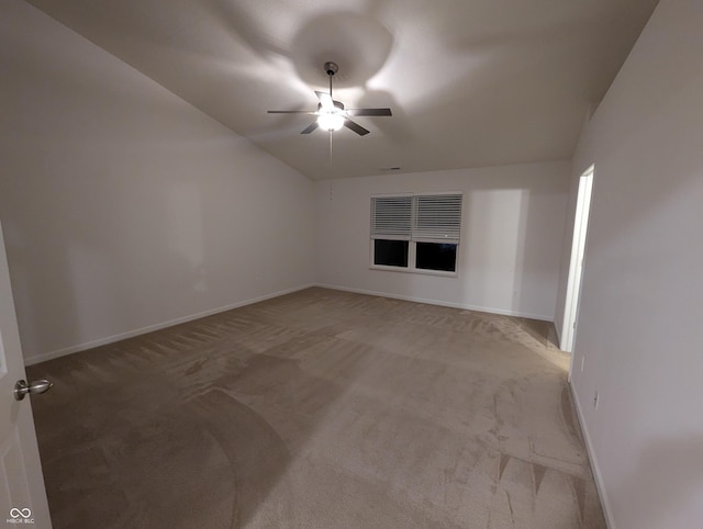 carpeted empty room with lofted ceiling and ceiling fan